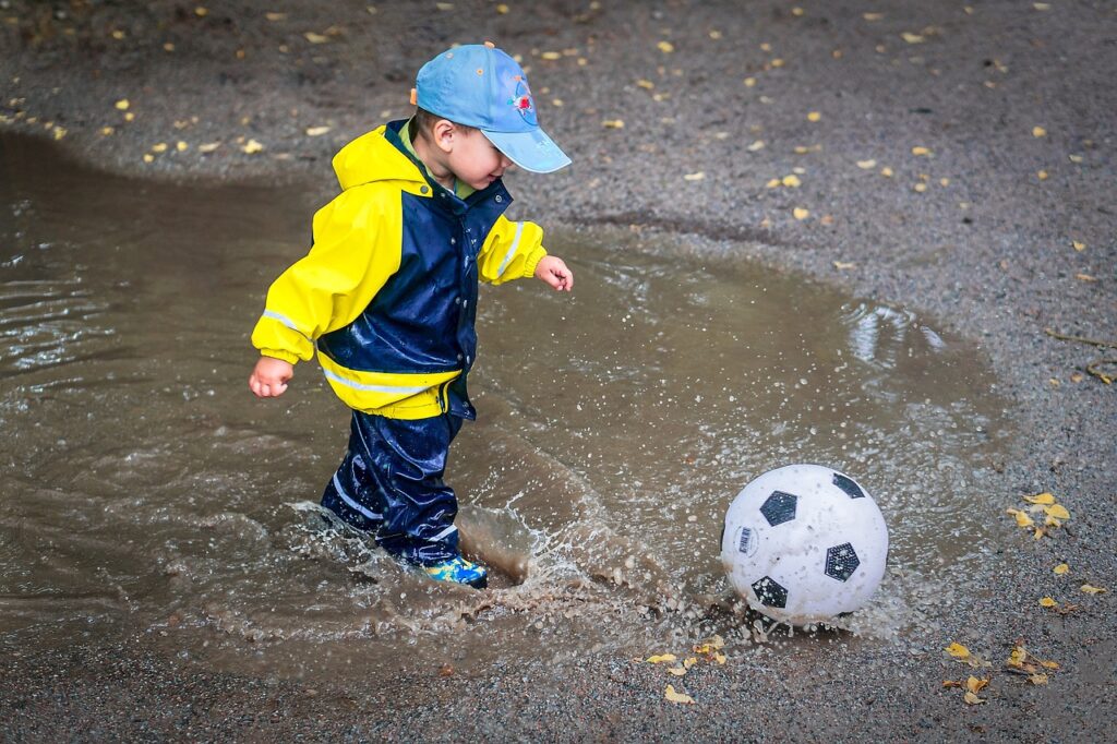 kid, child, young, childhood, happiness, outdoors, happy, playing, healthy, water, puddle, rings, hat, boy, son, happy kid, splash, nature, football, ball, rolling, jumping, drops, liquid, wet, rain, rubber, rain clothes, gray happy, gray water, gray rain, gray healthy, gray football, gray clothes, gray happiness