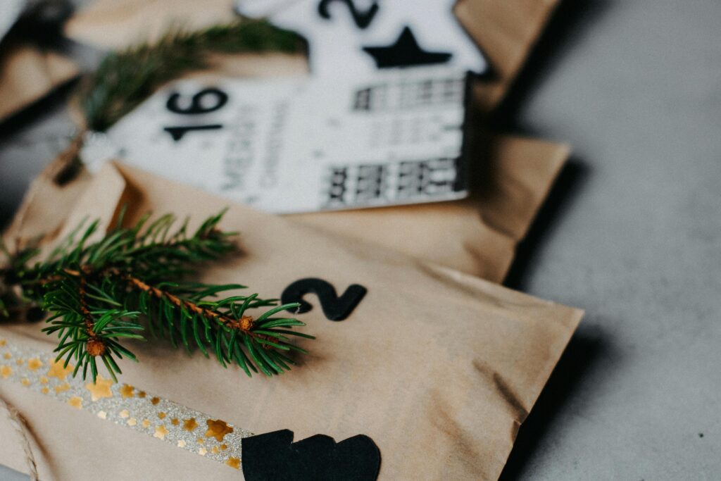 Close-up of a decorated advent calendar with evergreen sprigs for a festive touch.